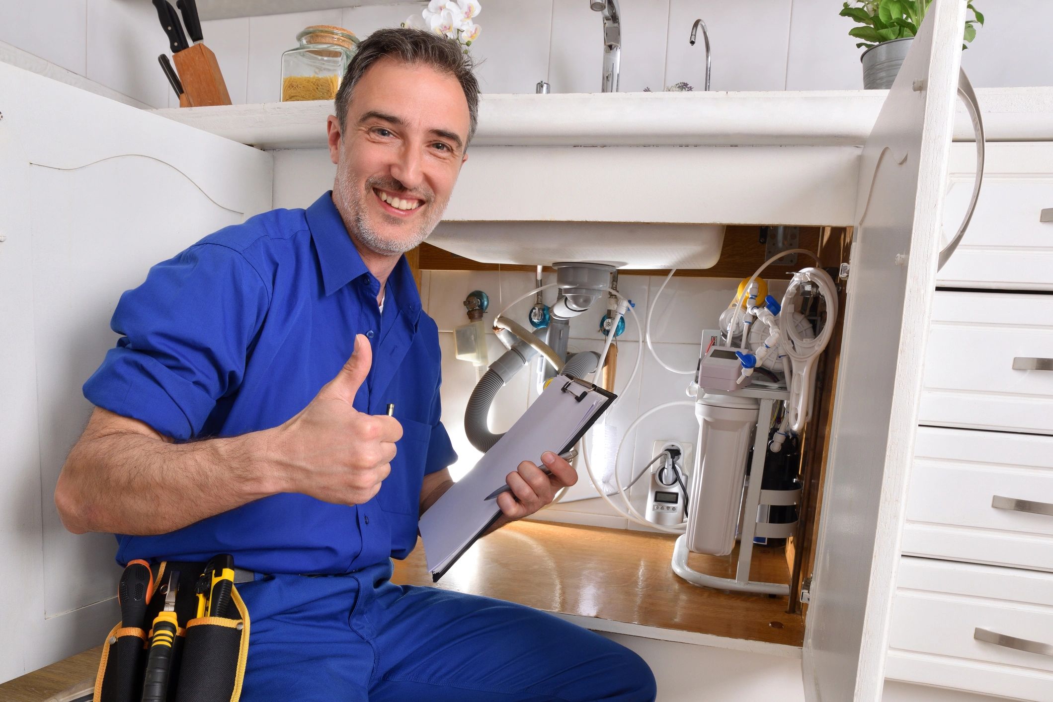 Plumbing technician with notepad checking installation
