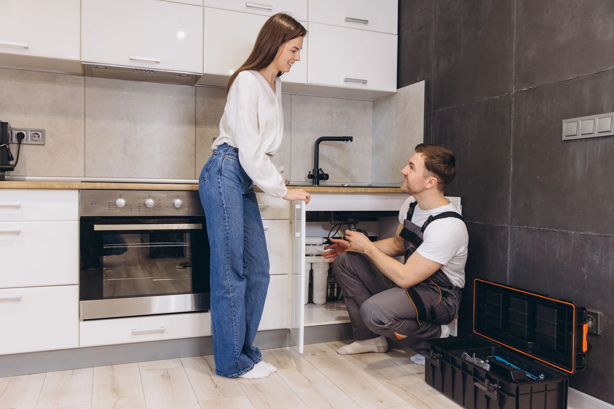 Plumber installing water filter