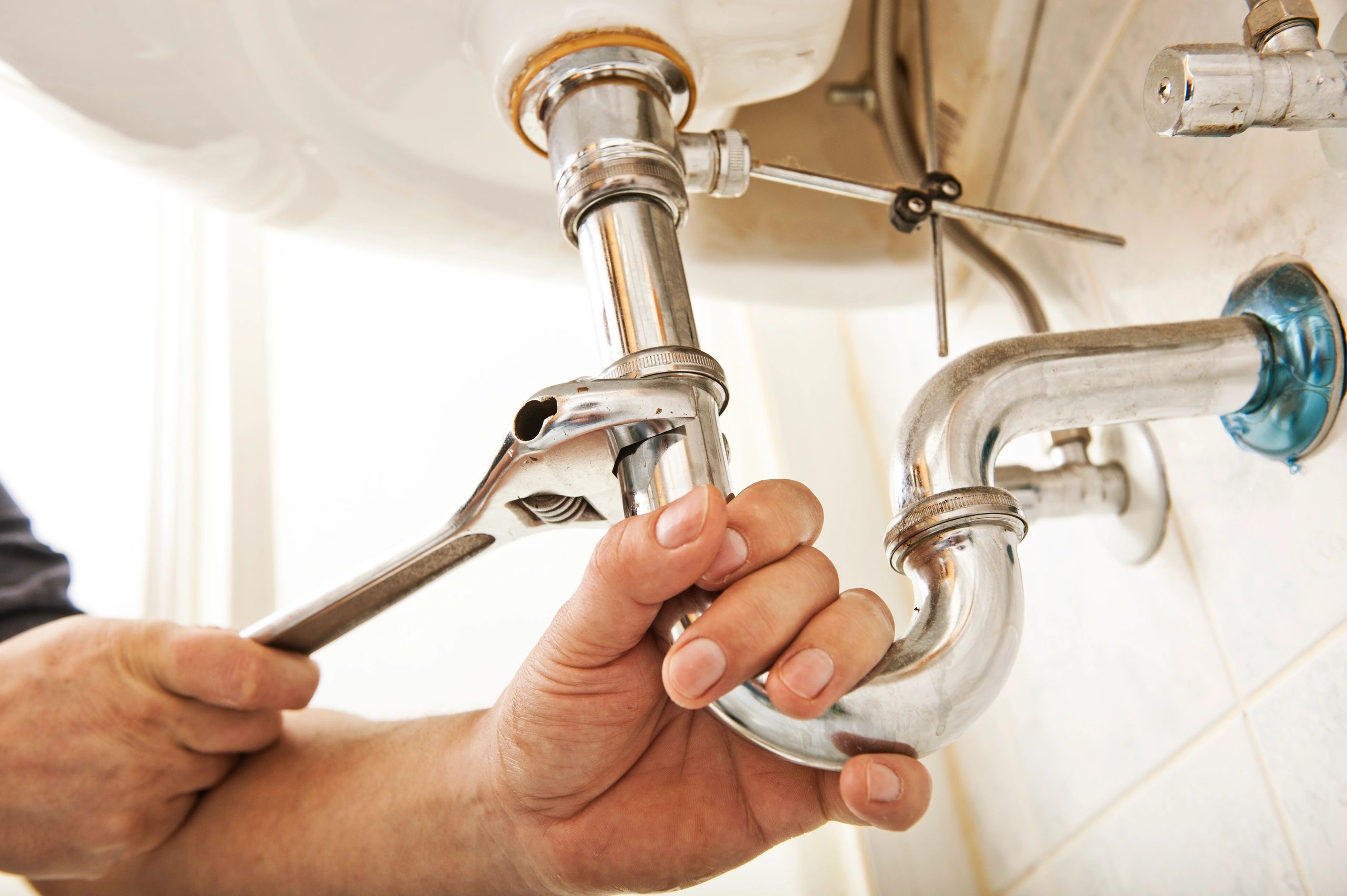 Plumber at work on residential pipe